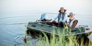 A father and son are fishing on a pond