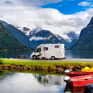 A motor home parked next to a lake