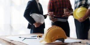 An engineer is meeting with contractors on a construction site