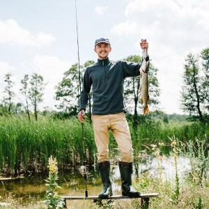 Angler smiling while holding the fish he caught