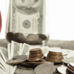 An image of a clock and money on a table.