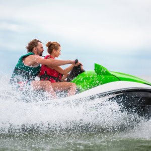 Man and woman riding a jet ski